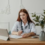 woman looking up from tablet